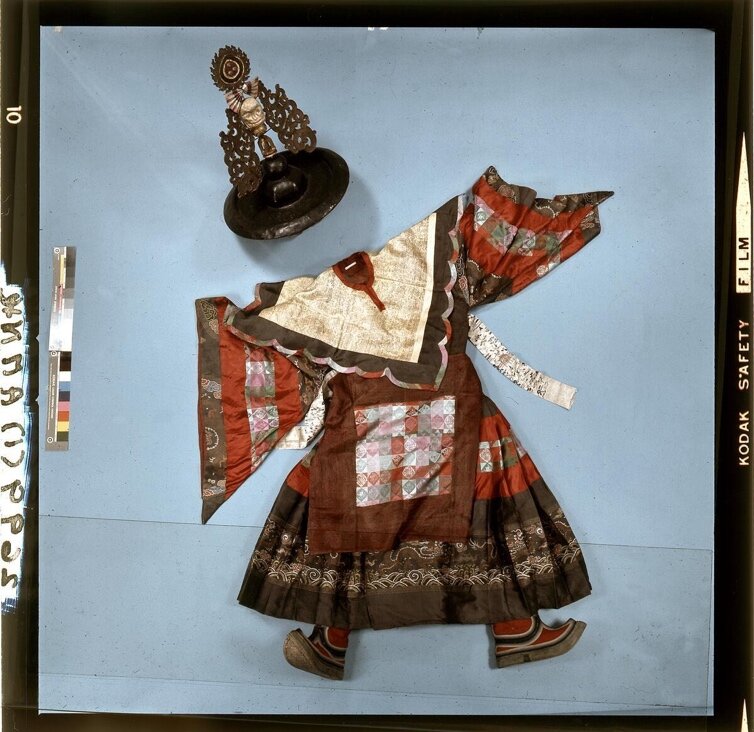 A ZhaNag Black Hat dancer's robe, ornamental collar and boots laid out for documentation, photographed by Thomas Beiswenger in 1970.